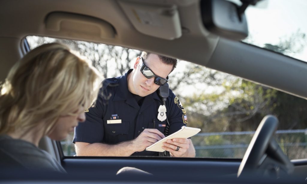 Officer writing a speeding ticket 